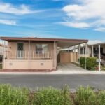 real estate home with a small, covered porch and attached carport