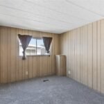 room with wood-paneled walls and a compact built-in shelf