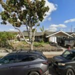 street scene with two parked cars in the foreground