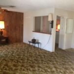room with brown paneled wall and table lamp