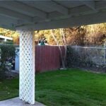 white patio cover with grassy yard